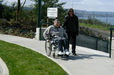 Man in a wheelchair on a sidewalk