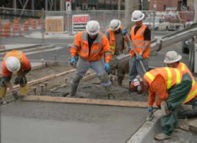 Contsruction workers building a sidewalk